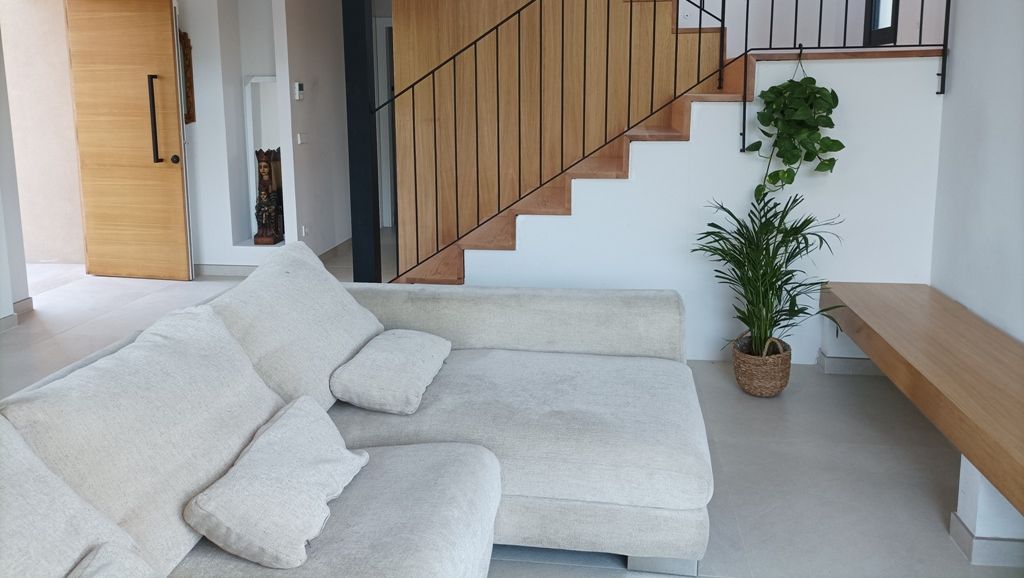 estancia moderna con sofa y escaleras